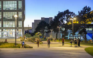 students walking on campus at dusk
