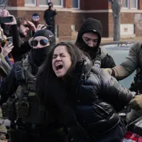 Federal immigration agents filmed dragging a woman from her car in Minneapolis