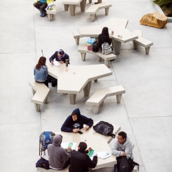 Ariel shot of students sitting at tables outside the library