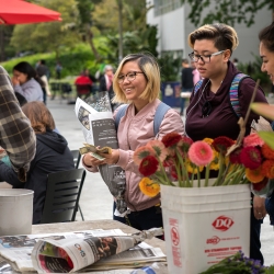 Female students purchasing flowers on campus